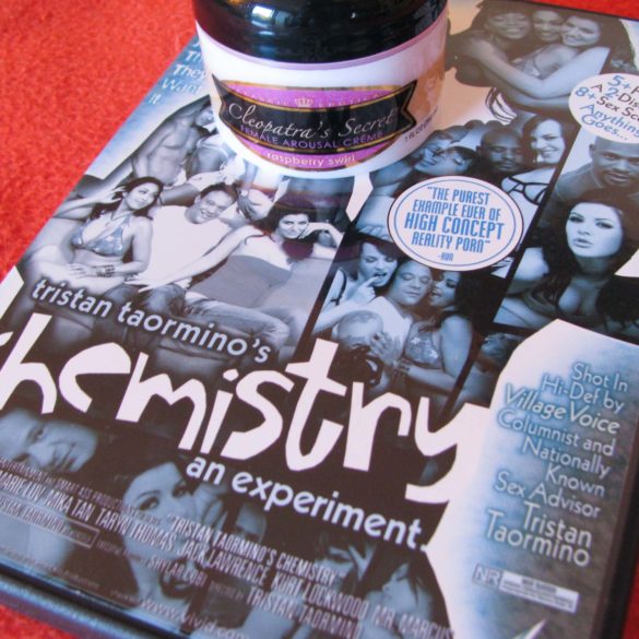 Chemistry Vol. 1 porn DVD by Tristan Taormino, lying on an orange blanket with a container of arousal cream on top.