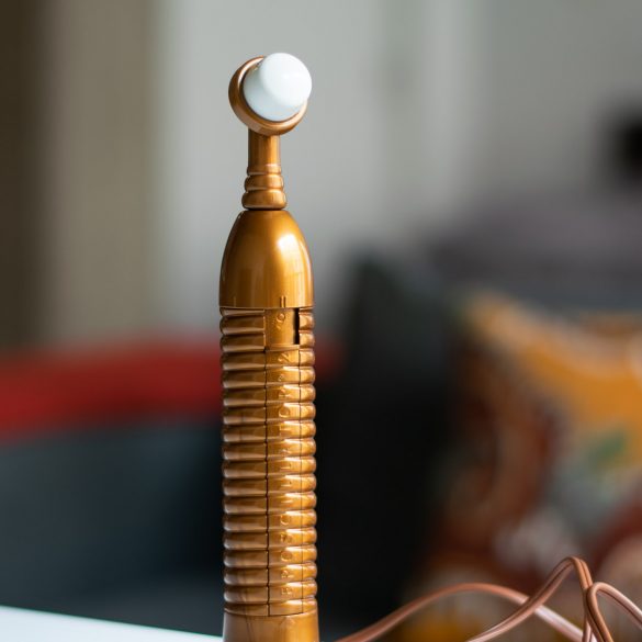 The Eroscillator standing proudly on a table, with the Ultra Soft Fingertip attachment (marshmallow) on it.