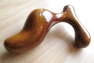 Romp butt plug in gorgeous honey-colored Mora wood.