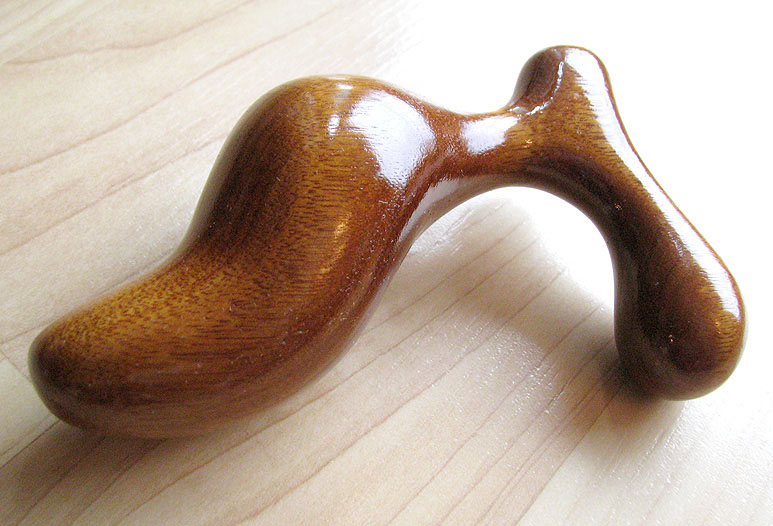 Romp butt plug in gorgeous honey-colored Mora wood.