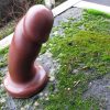 Vixen Creations Randy dildo in the chocolate color, chilling with some moss on my patio.
