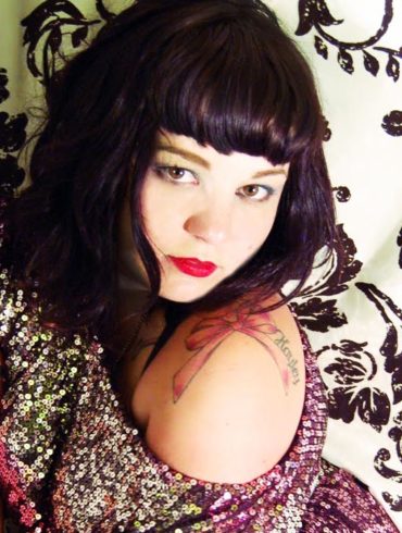 Courtney Trouble against a black and white paisley backdrop.