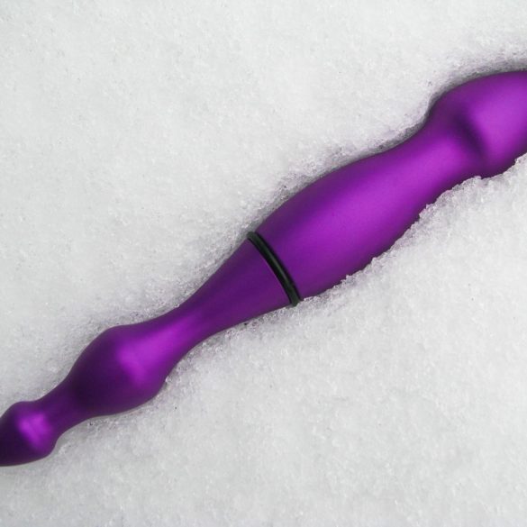 Purple aluminum dildo lying in the snow.