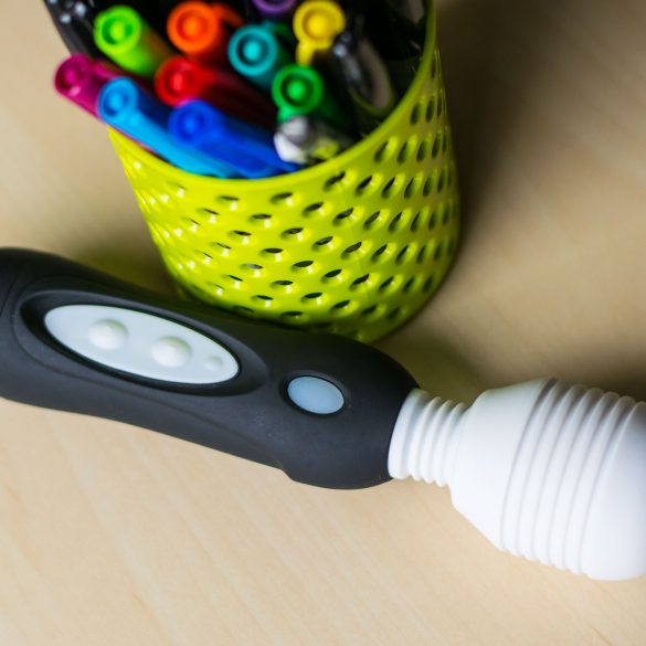 All hail the Vibratex Mystic Wand! On a desk next to a cute container of colorful sharpie pens.