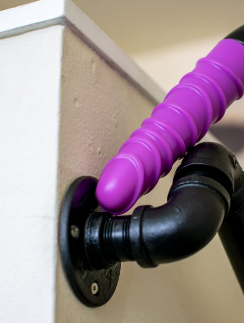Ophoria Bliss 8 silicone vibrator on a staircase railing made of old pipes.