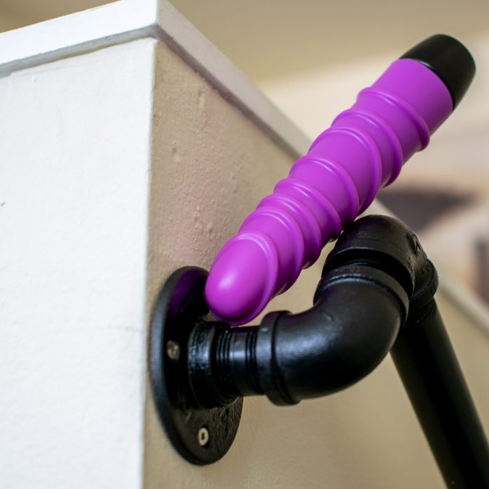 Ophoria Bliss 8 silicone vibrator on a staircase railing made of old pipes.