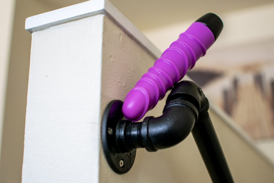 Ophoria Bliss 8 silicone vibrator on a staircase railing made of old pipes.