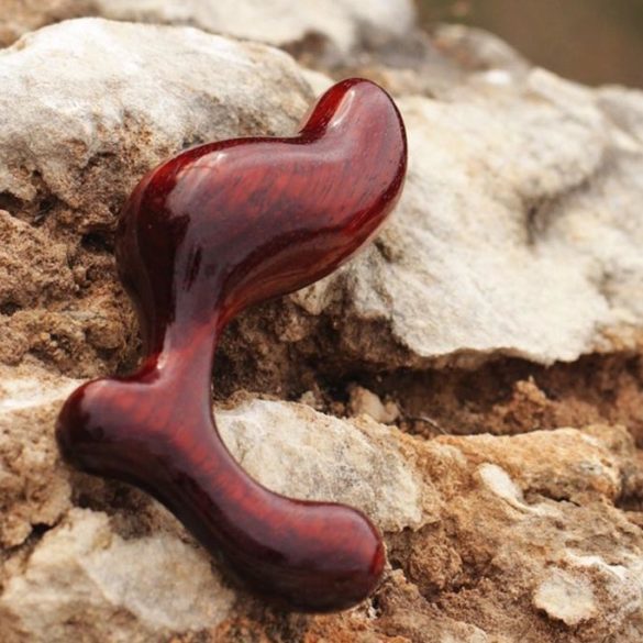NobEssence Romp anal plug, lying on a craggy rock in the great outdoors.