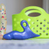 The polka dot Jollet and a purple Jollie standing next to each other, near a green shower caddy.