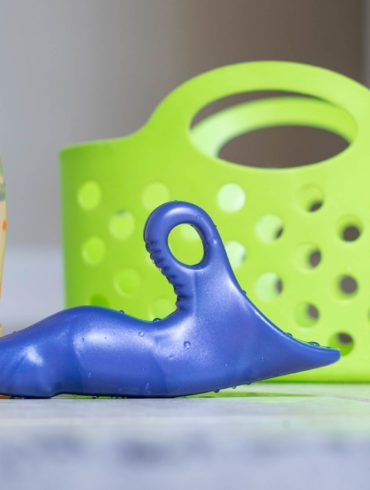 The polka dot Jollet and a purple Jollie standing next to each other, near a green shower caddy.