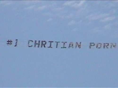 A banner in the sky which reads, "#1 CHRITIAN PORN"