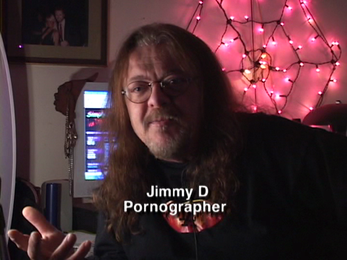 JIMMY D. PORNOGRAPHER. In front of a set of pink twinkle lights shaped like a cobweb.