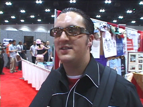 Dude at a porn convention wearing cool shades.