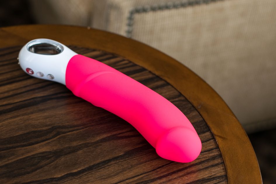 Fun Factory Big Boss G5 rechargeable vibrator on a wooden table.