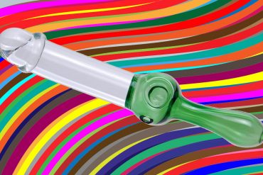 Pipedream Original Peter Piper pipe/dildo hybrid against a psychedelic rainbow background.