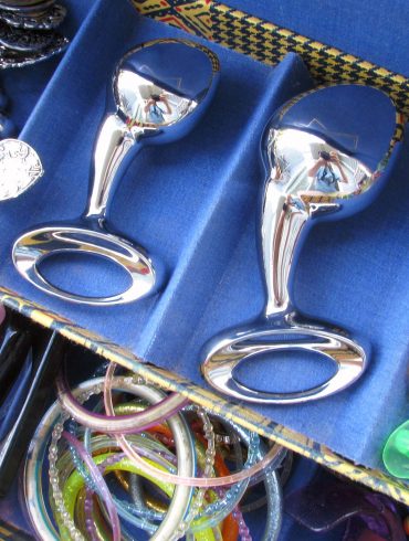 njoy Pure Plugs (medium and large) in a jewelry box with a bunch of gaudy bracelets and rings.