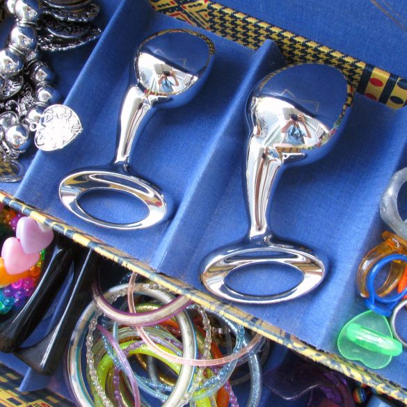 njoy Pure Plugs (medium and large) in a jewelry box with a bunch of gaudy bracelets and rings.