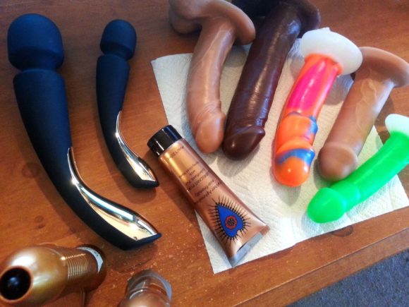From above shot of my desk littered with the LELO Smart Wand vibrators and many Vixen dildos.