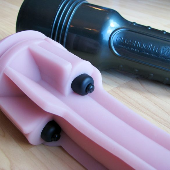 Fleshlight Vibro sleeve out of its case, showing the bullet vibrators nestled into pockets of the sleeve.