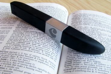 Lovehoney Flash USB rechargeable vibrator on top of a dictionary, open to the definition of "buzzy."