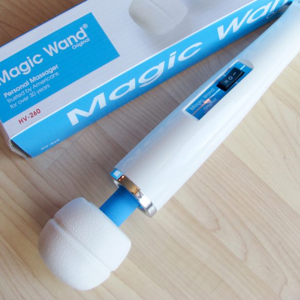Hitachi Magic Wand Original and its box, on a hardwood floor.