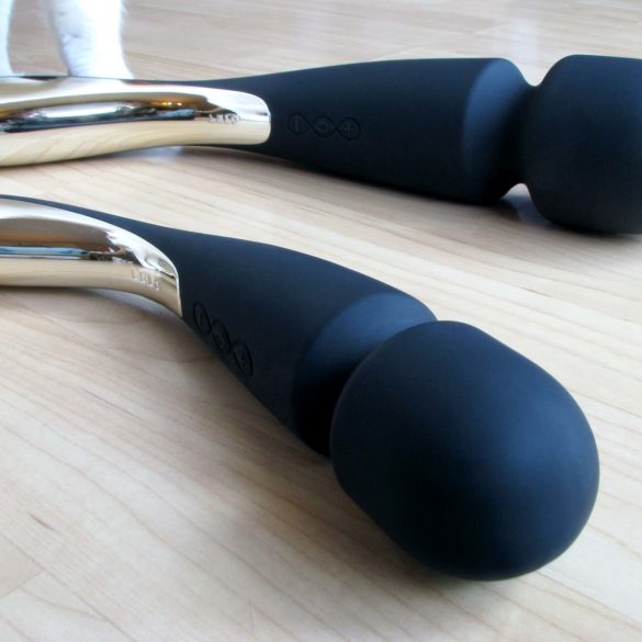 LELO Smart Wands, black with silver handles, lying on a hardwood floor.