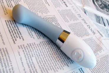 LELO Gigi 2 rechargeable G-spot vibrator on a newspaper.