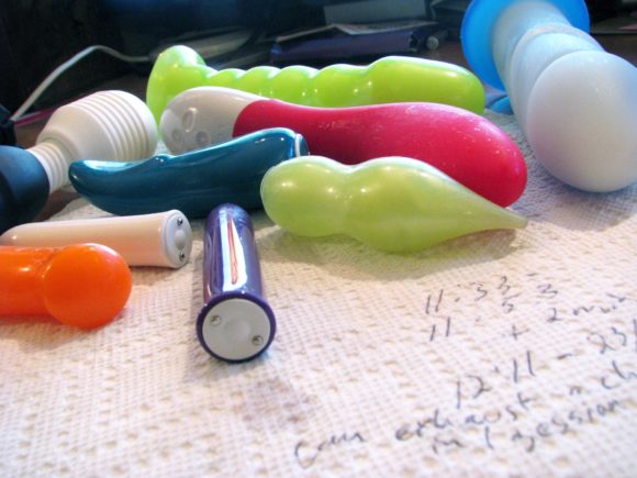 A bunch of dirtied sex toys lying on a paper towel (on which I've scribbled notes).