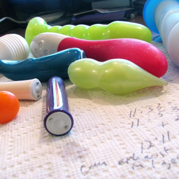 A bunch of dirtied sex toys lying on a paper towel (on which I've scribbled notes).