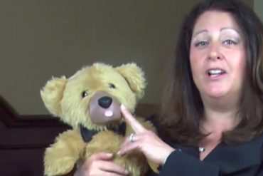Screenshot from the now-defunct Teddy Love crowdfunding video, of a woman touching a teddy bear's nose.
