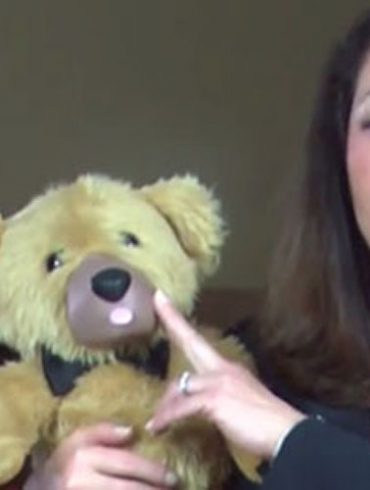 Screenshot from the now-defunct Teddy Love crowdfunding video, of a woman touching a teddy bear's nose.