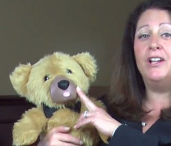 Screenshot from the now-defunct Teddy Love crowdfunding video, of a woman touching a teddy bear's nose.
