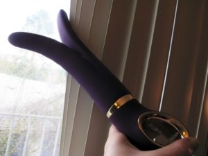 Fun Toys G-Vibe, a purple dildo with a split shape, creepin' on the neighbors through the blinds.