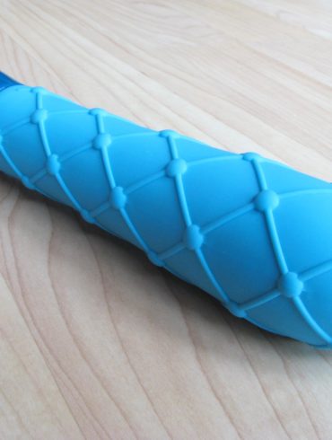 Jopen Key Ceres Lace vibrator lying on a hardwood floor.