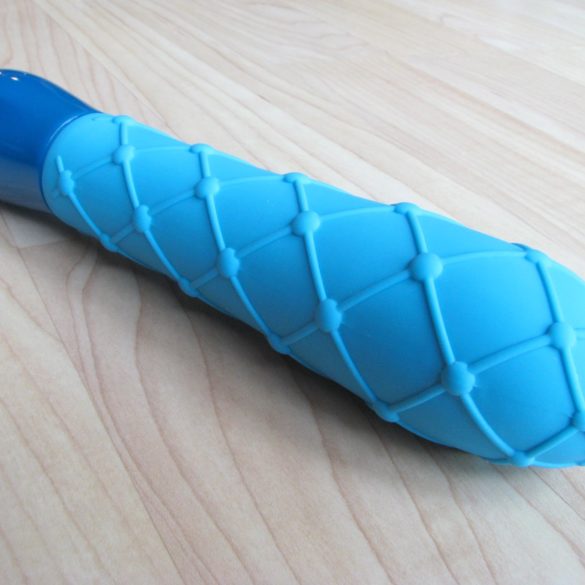 Jopen Key Ceres Lace vibrator lying on a hardwood floor.