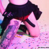 Person wearing an underwear-style strap-on with a tutu. And tats. And confetti.