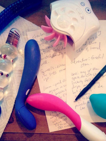 Sex toy masturbation session note taking, with dirtied toys lying on top.