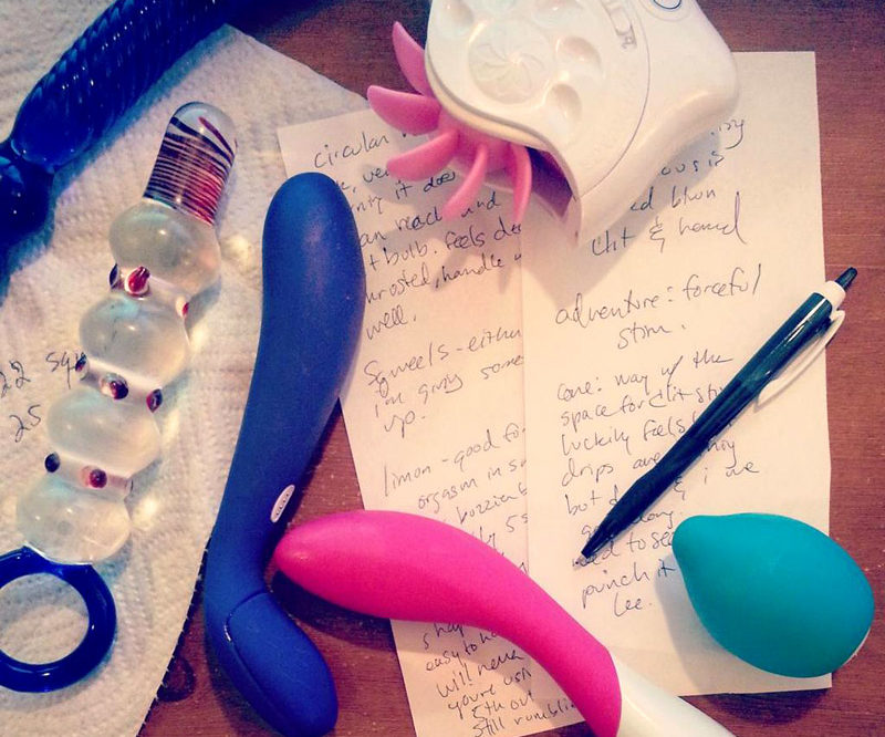 Sex toy masturbation session note taking, with dirtied toys lying on top.