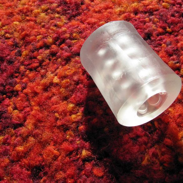 Bro Sleeve (Doc Johnson Helping Head masturbation sleeve) on fuzzy red and orange carpet.
