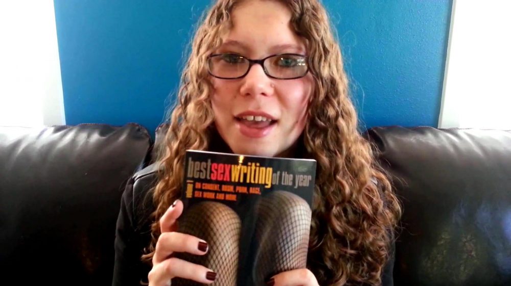 Me holding a copy of Best Sex Writing of the Year, Vol. 1