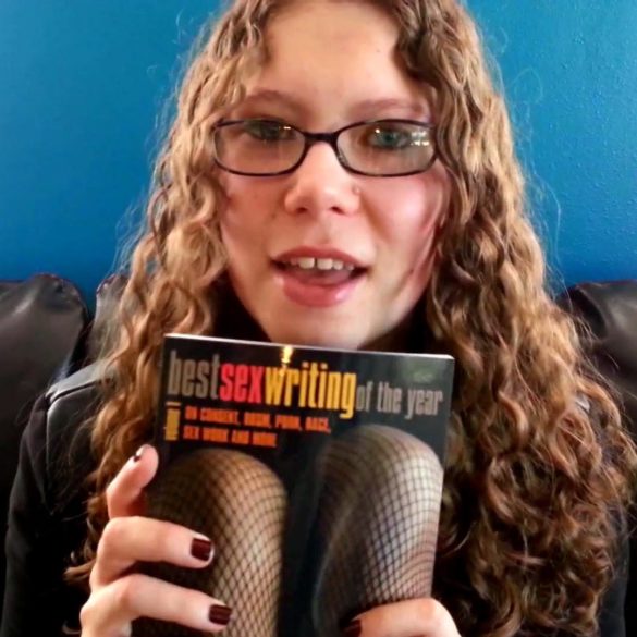Me holding a copy of Best Sex Writing of the Year, Vol. 1
