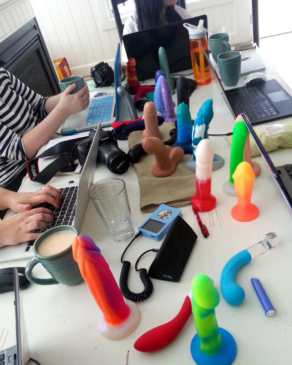 Table of dildos and laptops at #dildoholiday in Oregon.