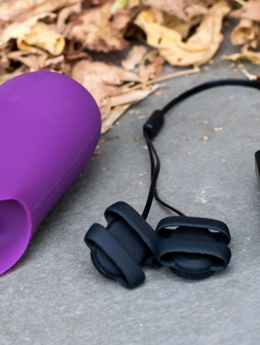 Jimmyjane Form 5 and Hello Touch X vibrators (plus masking tape labels) next to some fall leaves.