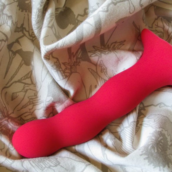 Fun Factory Bouncer kegel ball dildo on an off-white crumpled sheet.