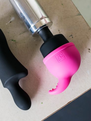 Doxy Don and Doxy Die Cast on a desk. The Nuzzle Tip attachment is on the Doxy Die Cast's head.