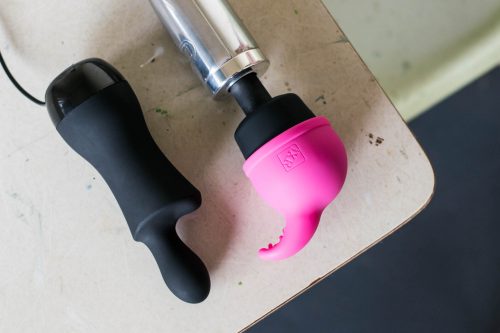 Doxy Don and Doxy Die Cast on a desk. The Nuzzle Tip attachment is on the Doxy Die Cast's head.