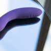 We-Vibe Rave rechargeable app-compatible G-spot vibrator on a reflective table.