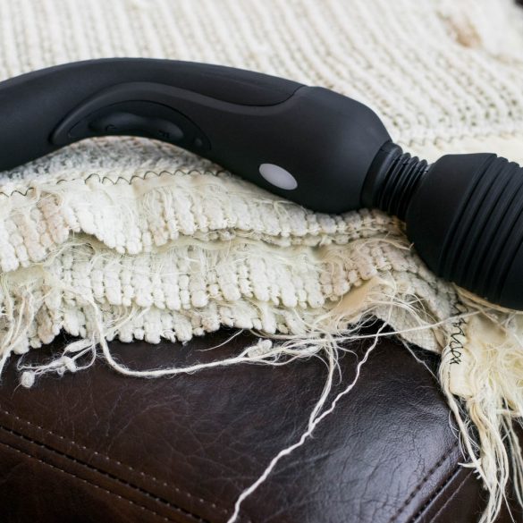 Vibratex Mystic Wand Rechargeable vibrator lying on a tattered cream-colored blanket.