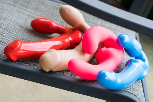 Four strapless strap-on dildos leaning on each other: Tantus Feeldoe More, Tantus Realdoe Stout, Fun Factory ShareVibe, Fuze Tango.