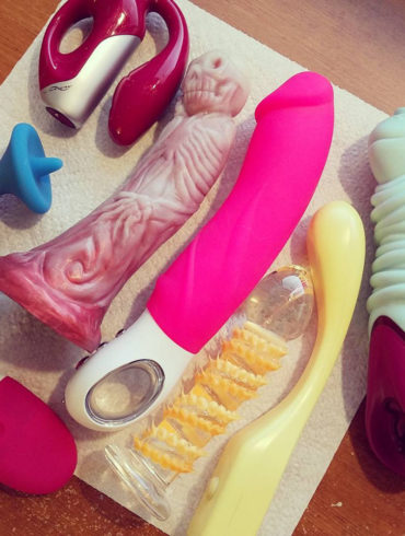 An assortment of sex toys from the past, including one that looks like a skeleton and another with orange spikes.